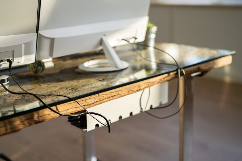 Organized cords can make your home office feel less cluttered. Take advantage of a cable manager to keep things neat.