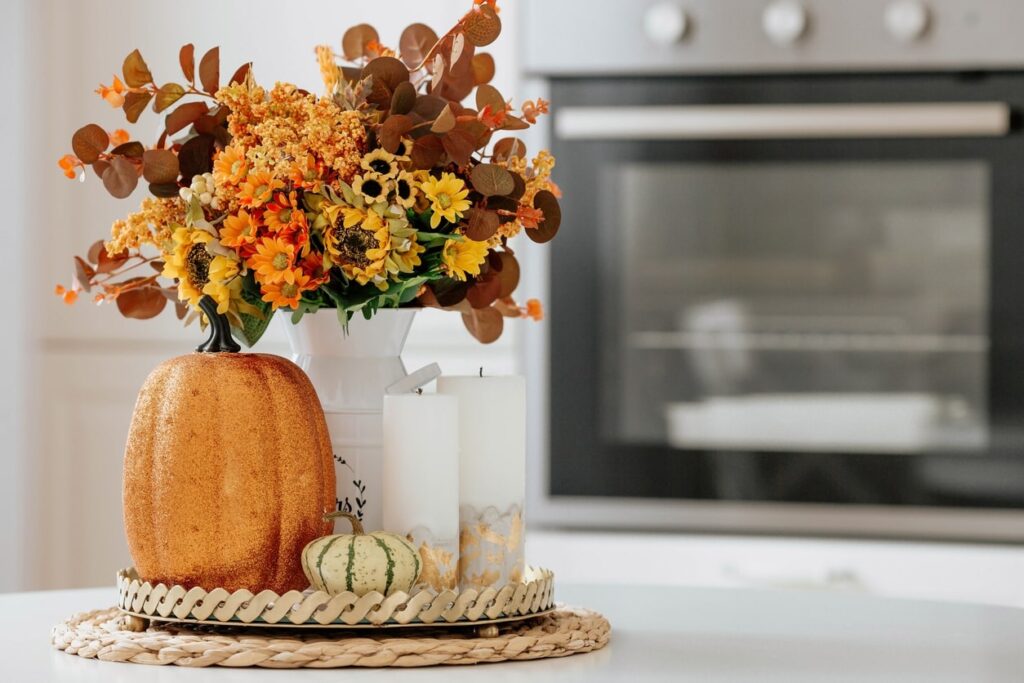 Decorate surfaces with tasteful, fall-themed items like candles, plants, and pumpkins.