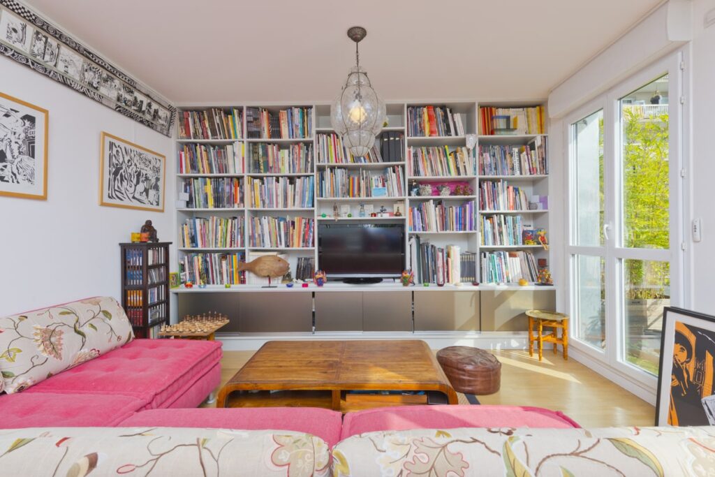 Floor-to-ceiling shelves filled with books, photos, and precious mementos make a room feel more spacious and simple.
