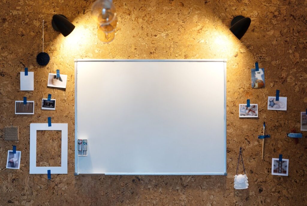 In a small home office, use all the space you can by adding corkboard on your wall.